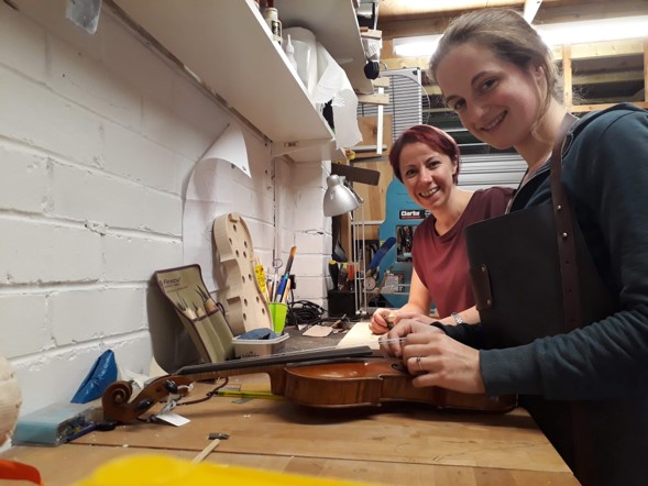 Chloe and Sophy at work setting up violins at The Violin Company
