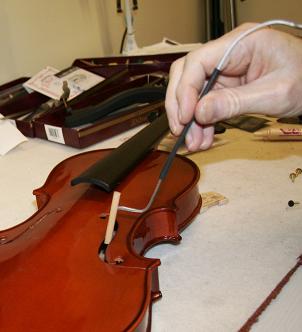 Picture showing how to insert a soundpost into a violin